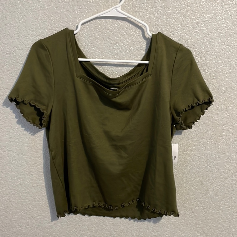 This is a GAP army green shirt with little ruffles on the sides and bottom seams